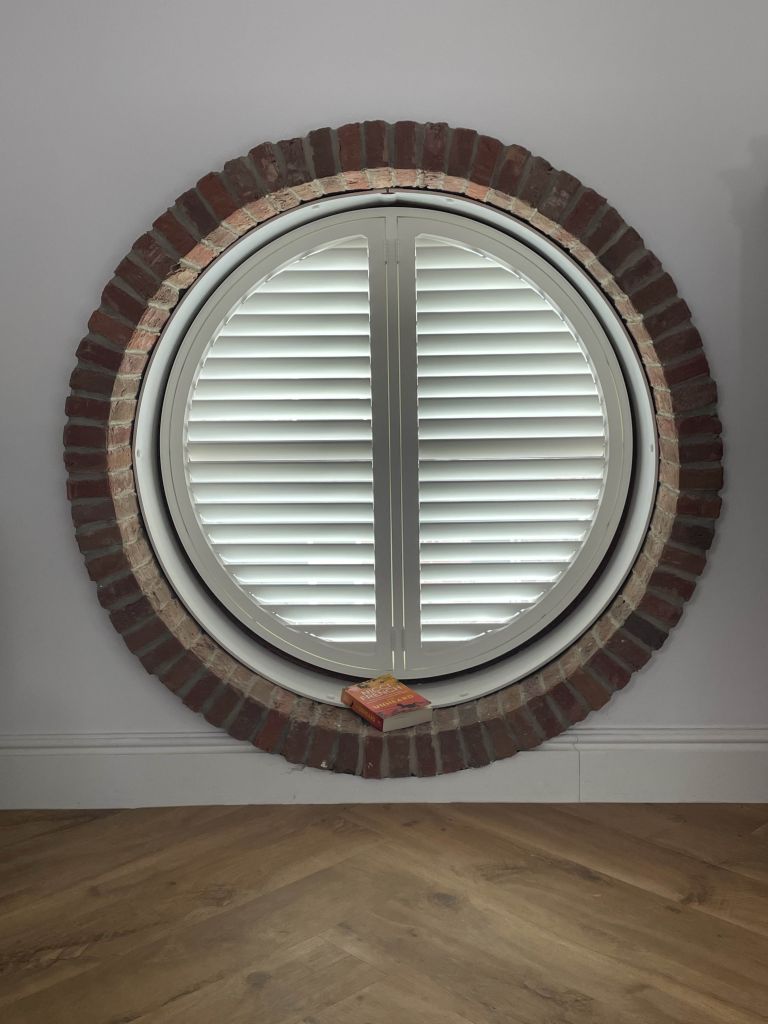 Shutters for shaped circular windows, supplied and fitted by The Valley Shutter Co West Yorkshire and North West England.